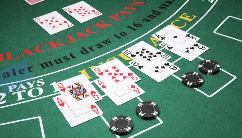 a blackjack table set up with playing cards and gaming chips laid out